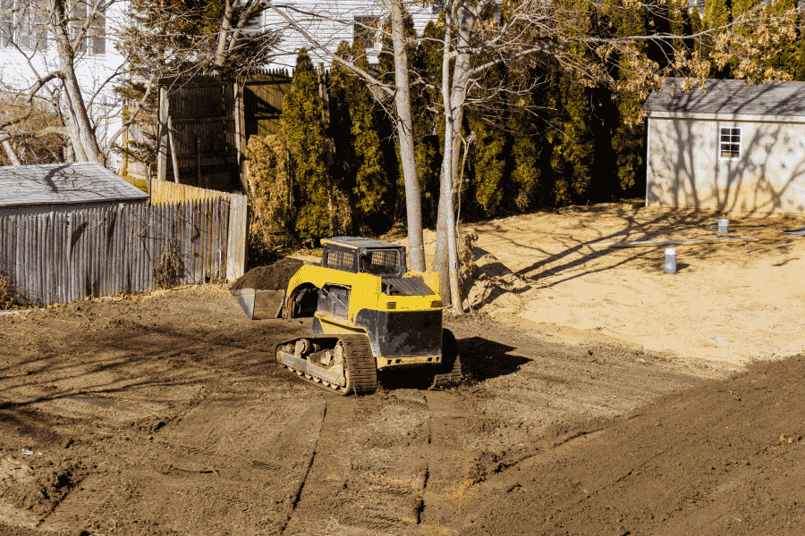 yellow machine clearing a land